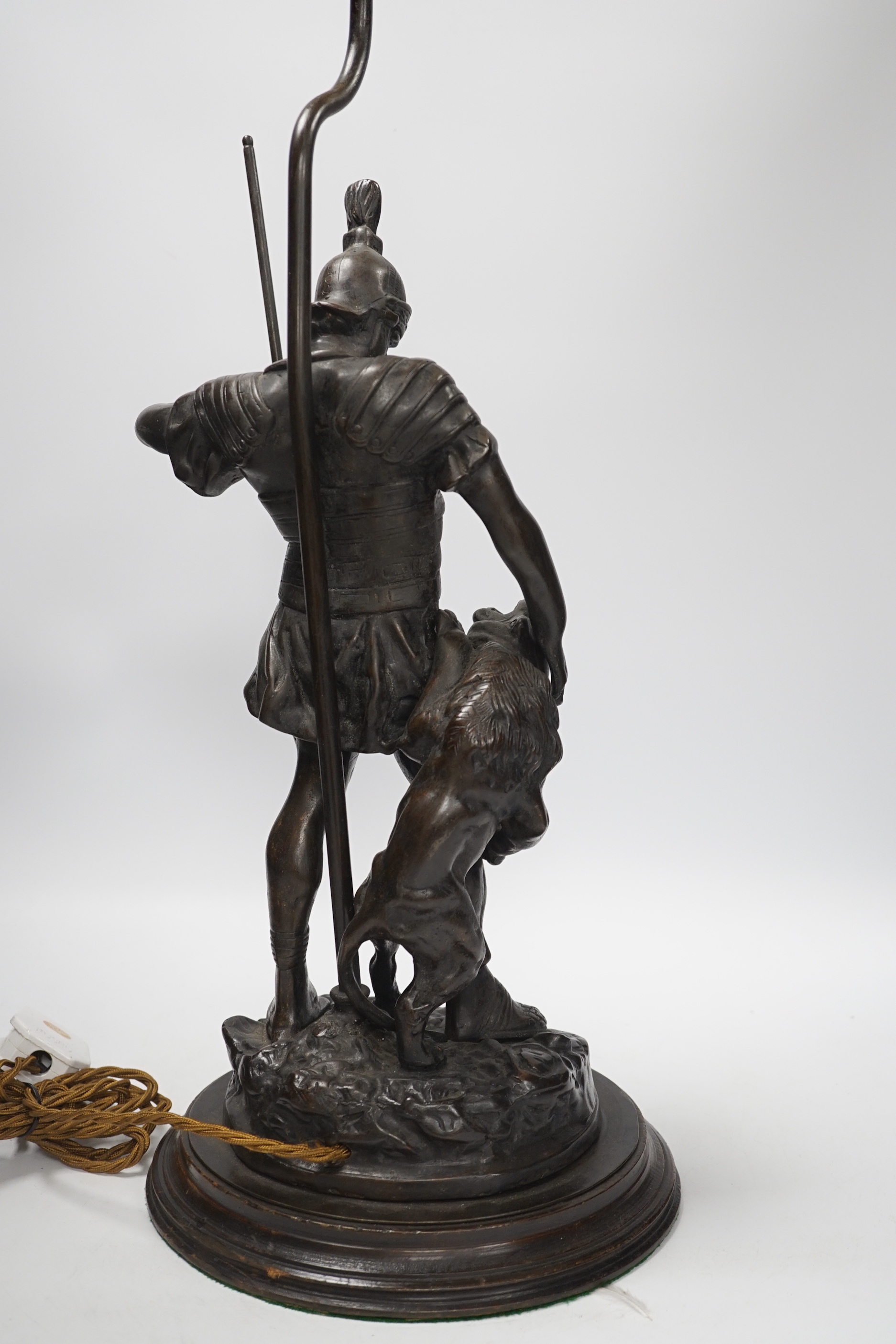 A bronze Roman soldier and lion table lamp, 60cm high including light fitting